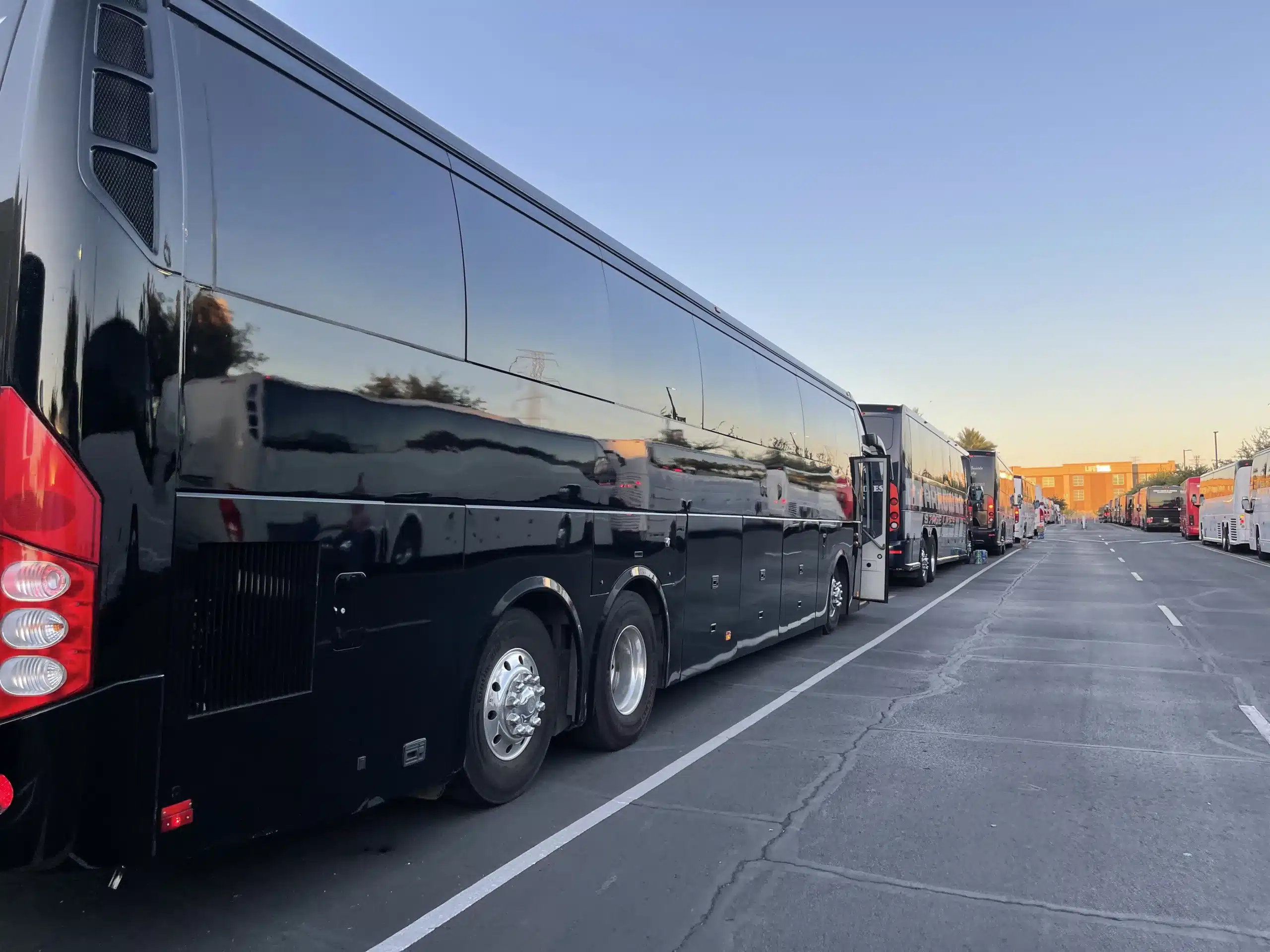 Black Bus Rentals Albuquerque Divine Charter Buses lined up at sunset