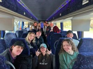 people riding in a charter bus