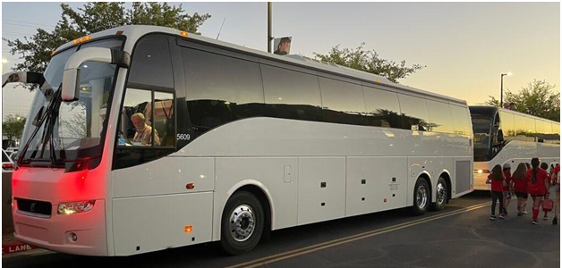 a white charter bus parked outside